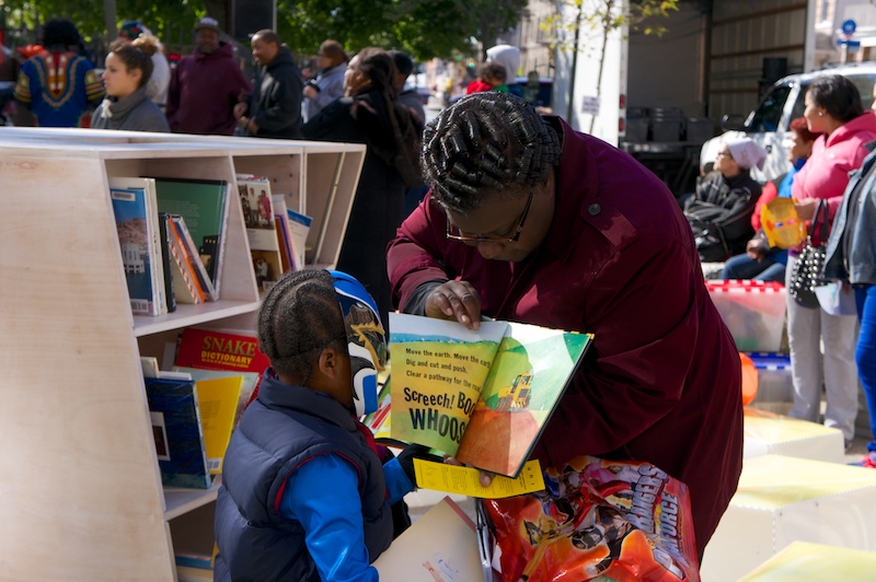 Reading together in public on Pitkin Plaza, Brooklyn