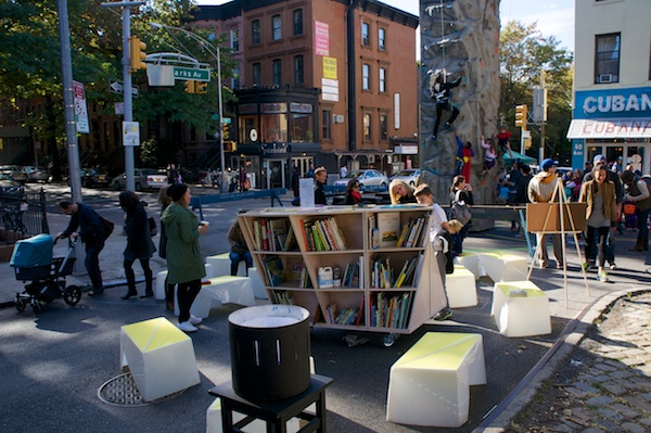 Reading books instead of parking cars along Flatbush Ave in Brooklyn